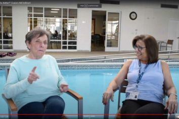 Women sitting in front of pool