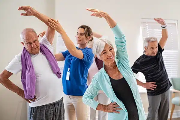 Seniors in stretching class to help with fall prevention