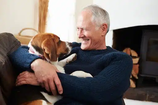 Senior man with his dog in the best dogs for senior article